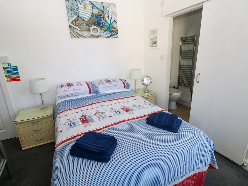 A bedroom with a bed and bedside table at 3 Edward Street Tenby