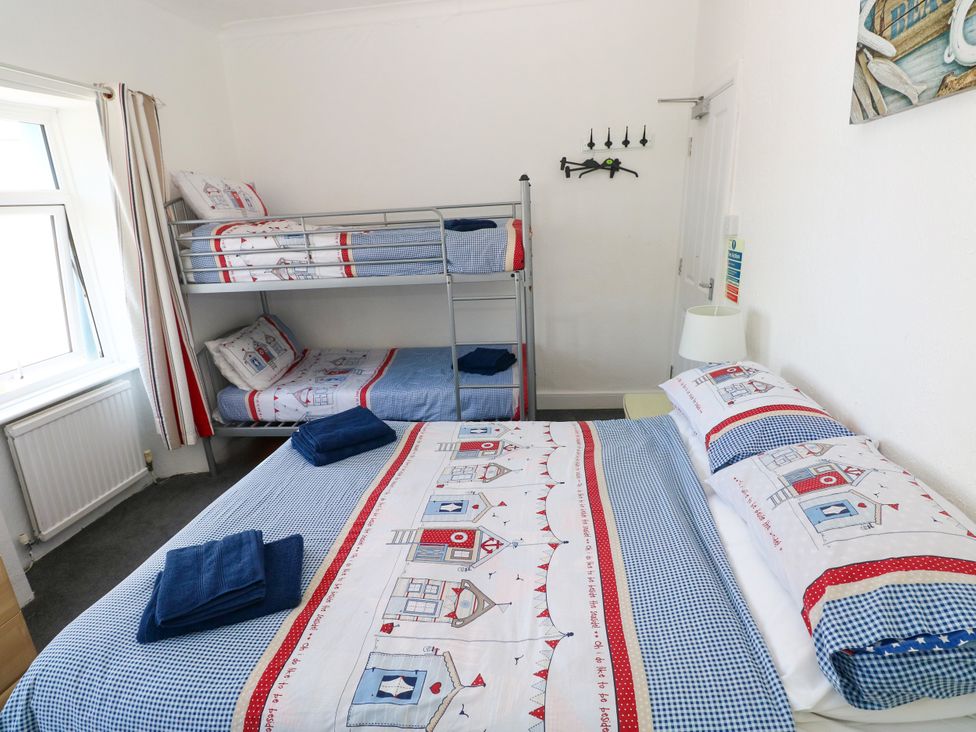 A bedroom with a bunk bed and a double bed at 3 Edward Street Tenby