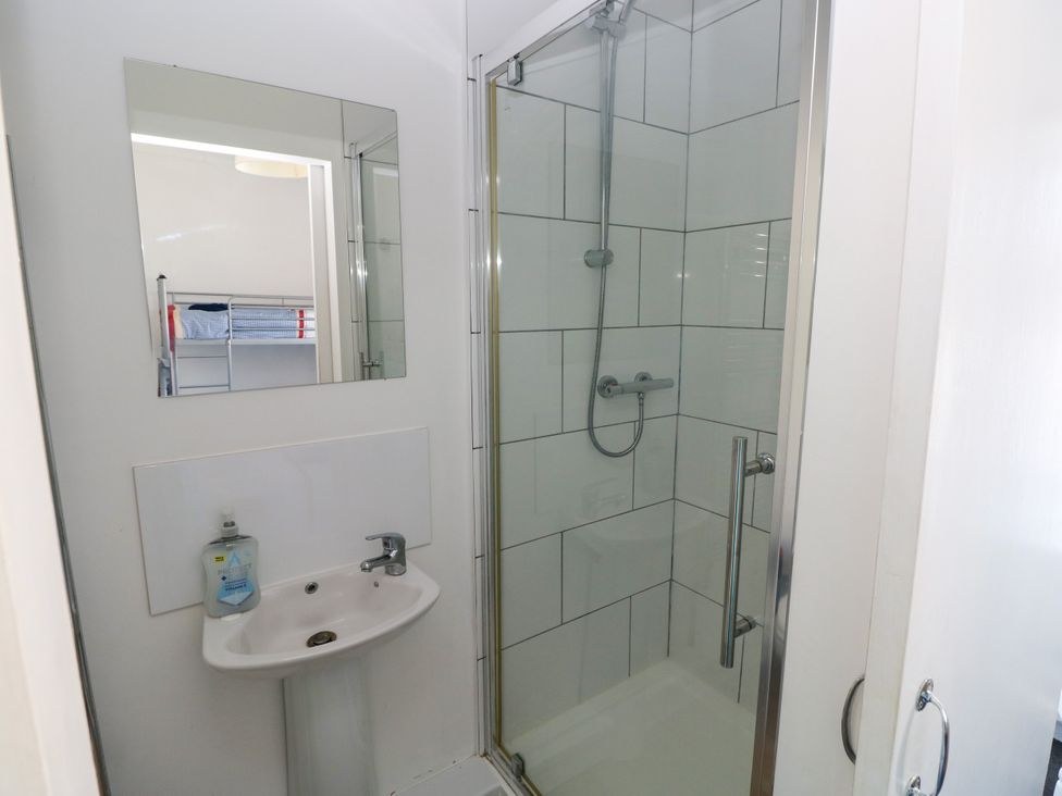 A bathroom with a shower and sink at 3 Edward Street in Tenby