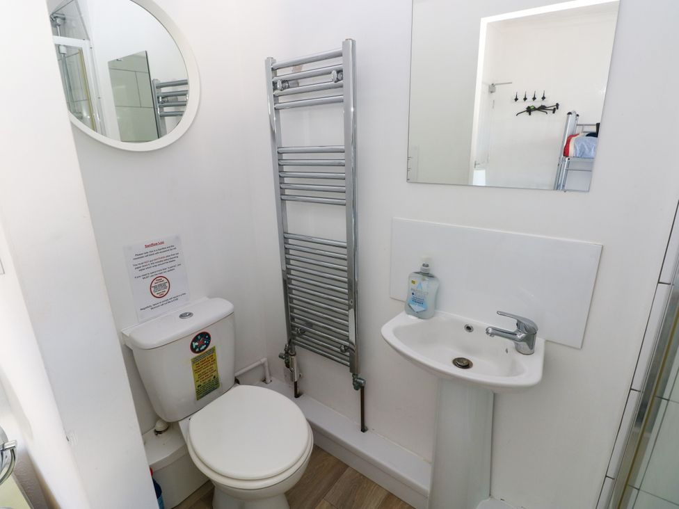 A bathroom with a toilet and sink at 3 Edward Street Tenby