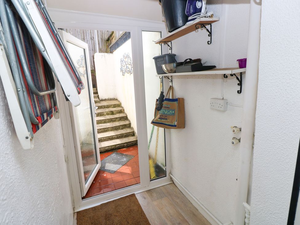A hallway with stairs leading outside at 3 Edward Street Tenby