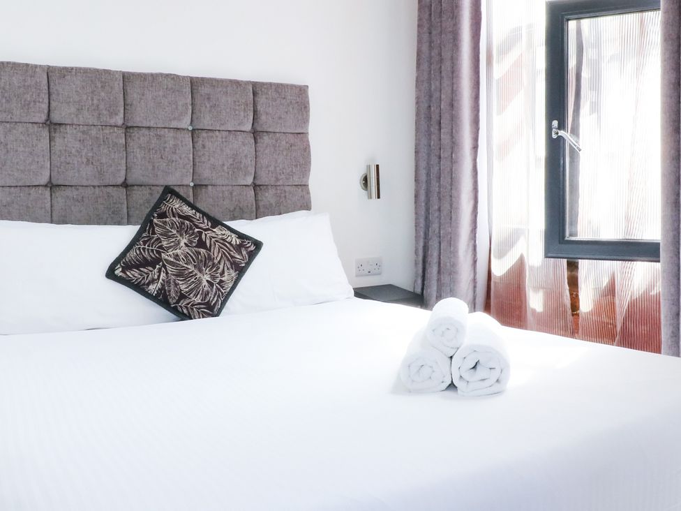 A bedroom with a bed and towels neatly arranged at Apartment 304 Nottingham