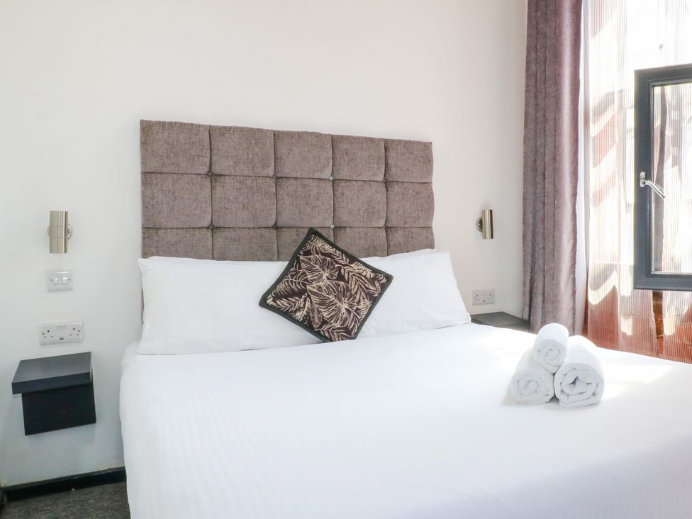 A bedroom with a bed and pillows at Apartment 310 in Nottingham