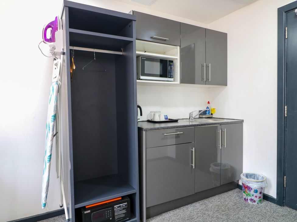 A kitchen with a microwave and sink at Apartment 310 in Nottingham