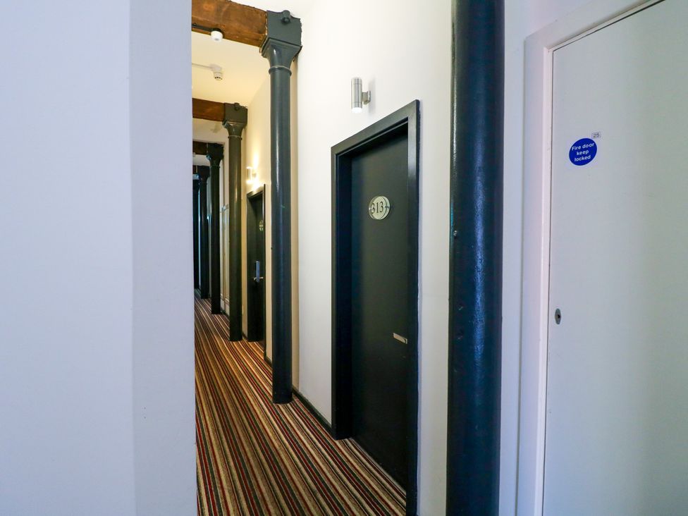 A corridor with doors and light fixtures at Apartment 310 Nottingham