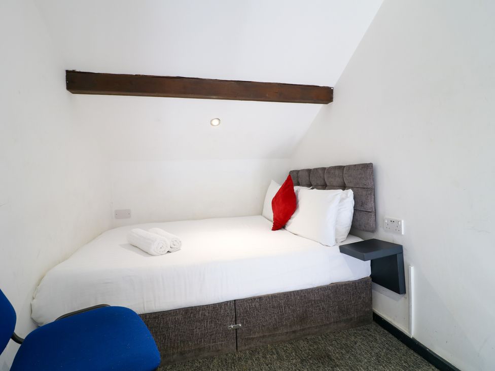 A bedroom with a bed and chair at Apartment 610 in Nottingham