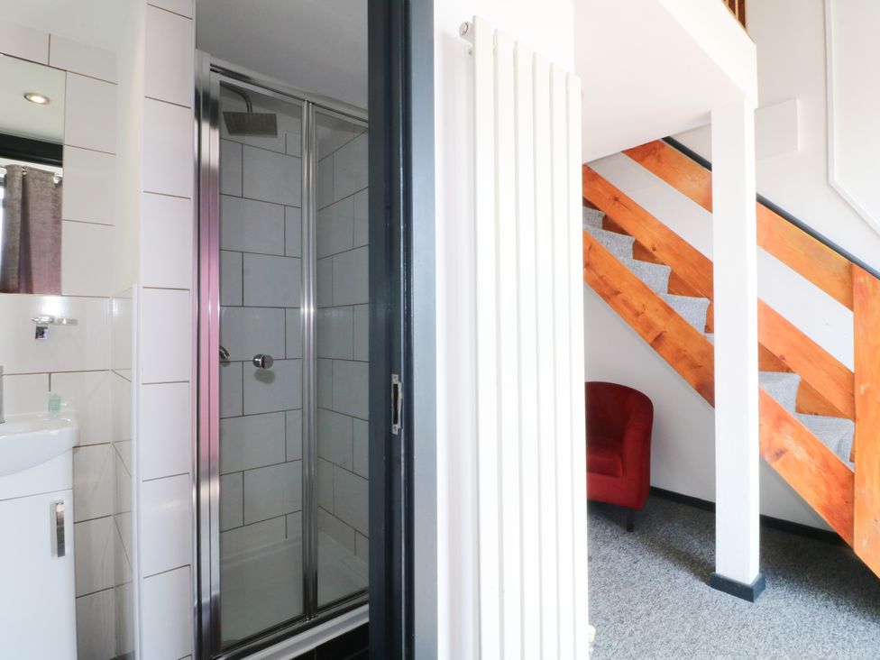 A bathroom with a shower and a staircase at Apartment 610 Nottingham