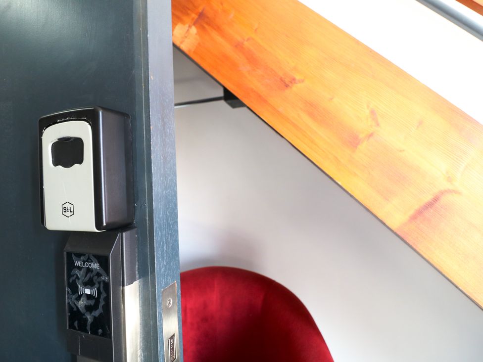 A door with a sanitizer dispenser and welcome sign at Apartment 610 in Nottingham