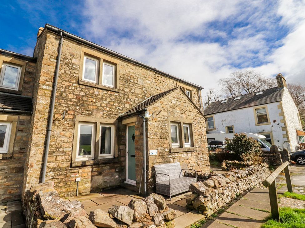 A stone house with windows and a front door at 2 Rock View in Settle