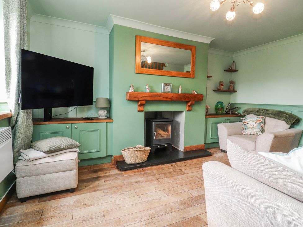 A living room with a television and fireplace at 2 Rock View Settle