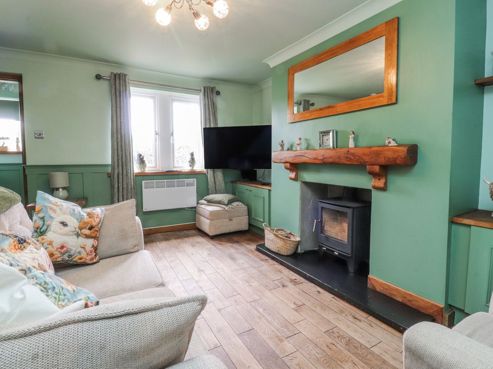 A living room with a sofa and television at 2 Rock View Settle