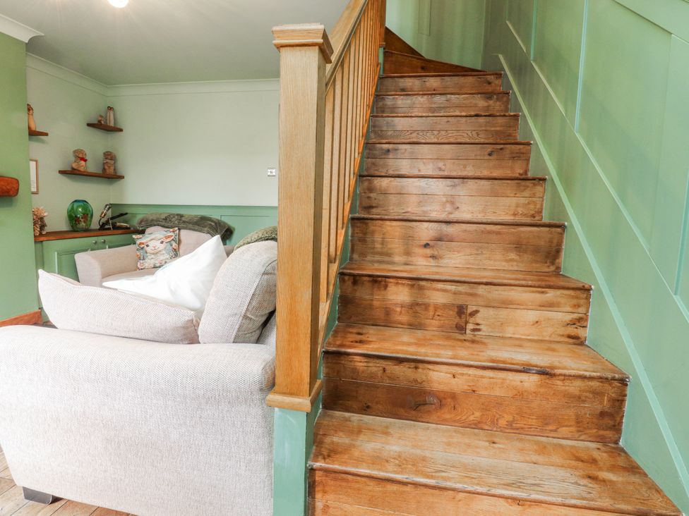 A staircase and a sofa in a living room at 2 Rock View Settle