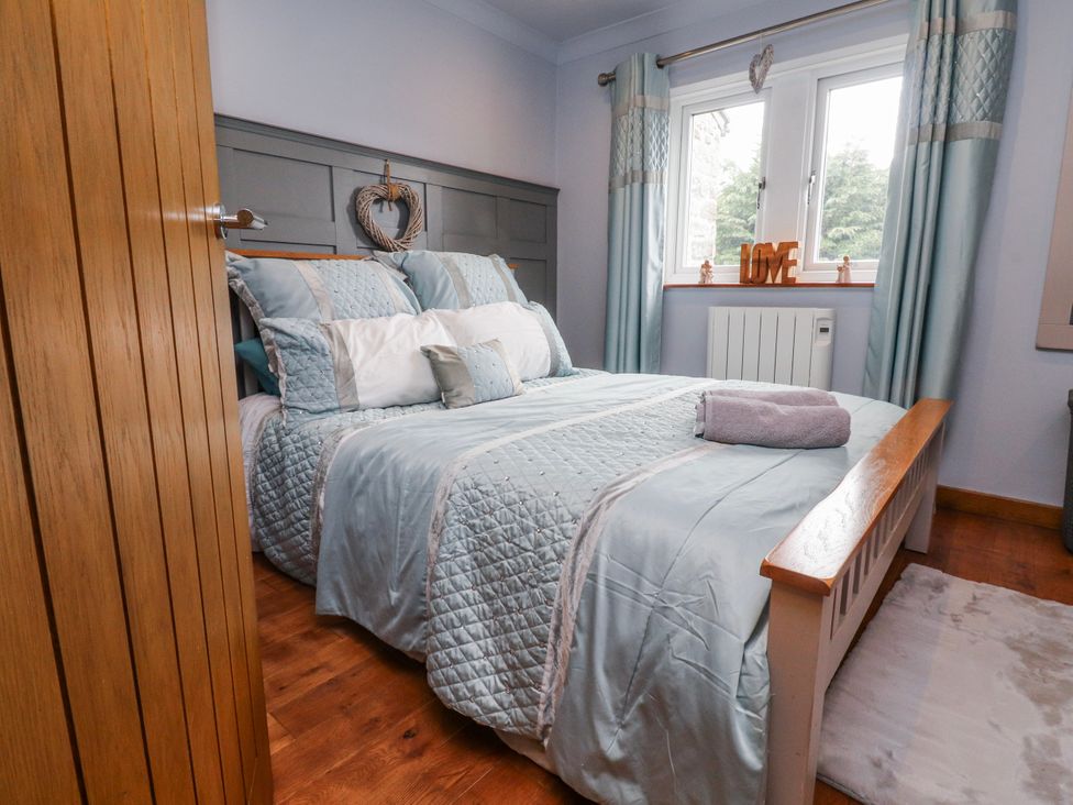 A bedroom with a bed and window at 2 Rock View Settle