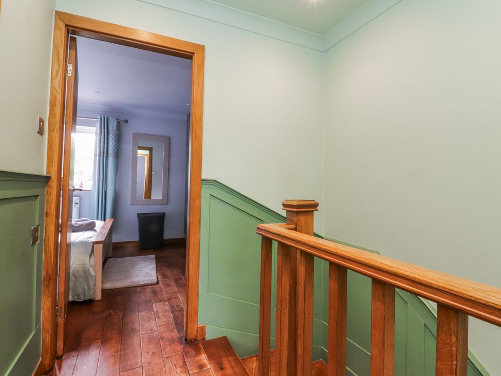 A landing area with a staircase and view into a bedroom at 2 Rock View Settle