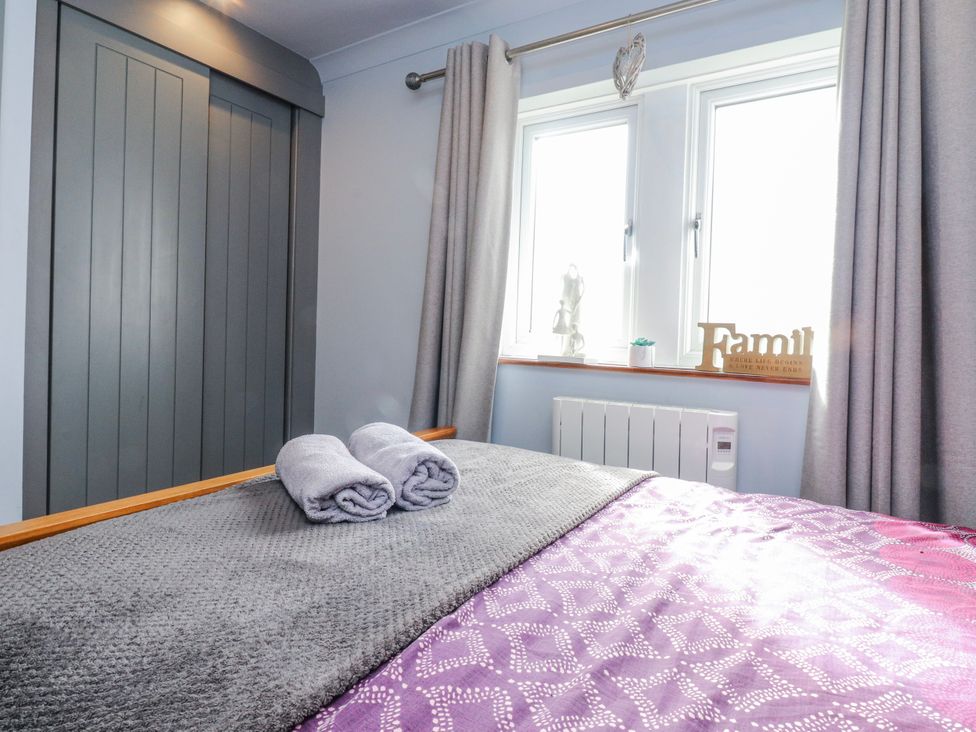 A bedroom with a bed and two towels at 2 Rock View in Settle