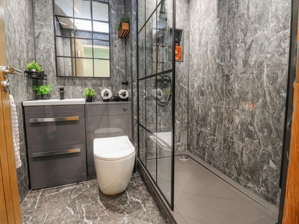 A bathroom with a sink, toilet, and shower at 2 Rock View, Settle