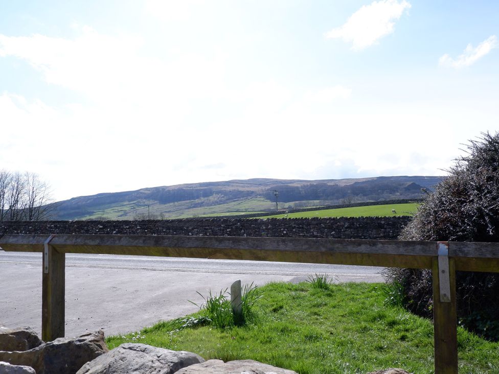 A view of hills and a fence near the road at 2 Rock View near Settle