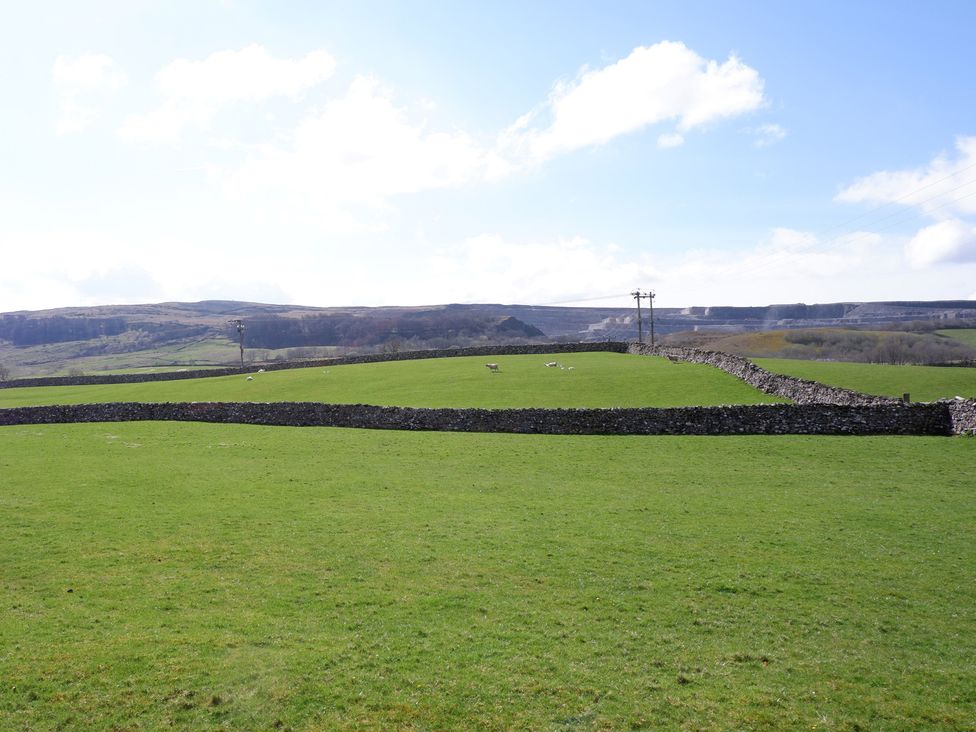 An outdoor scene of a field with stone walls and hills at 2 Rock View near Settle
