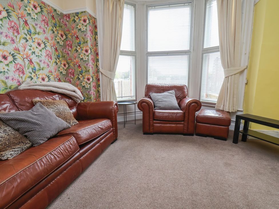 A living room with a sofa and armchair at 30 Prospect Hill in Whitby