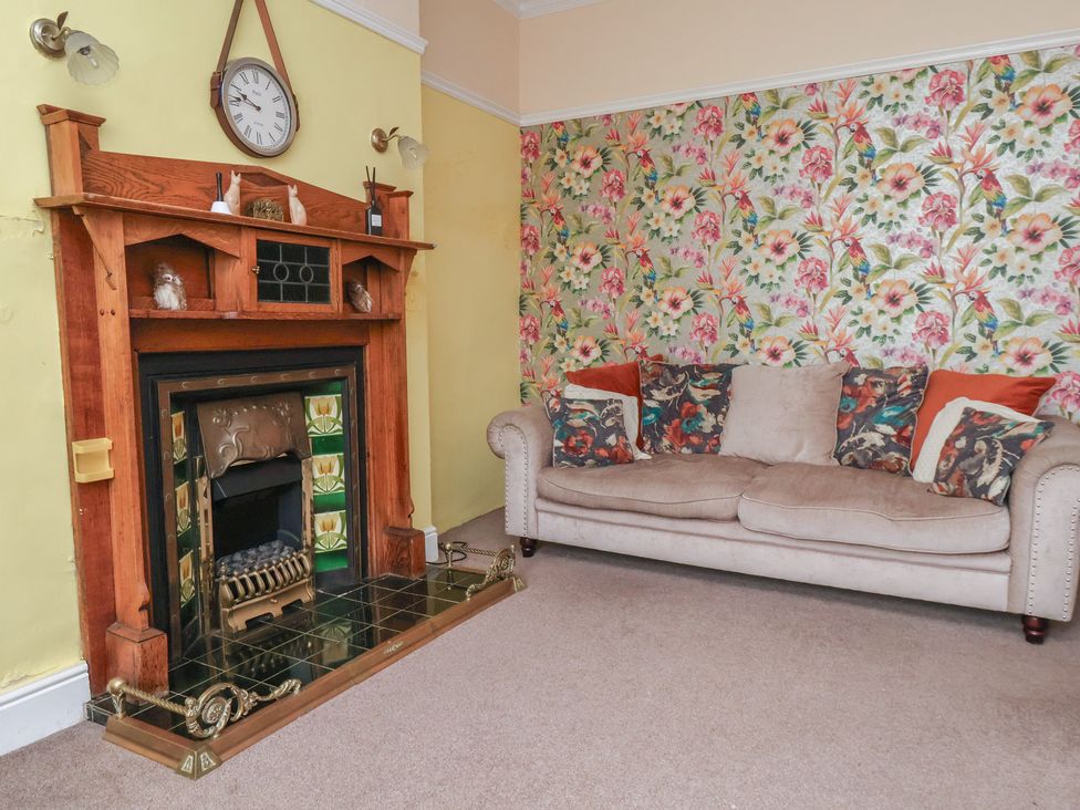A living room with a fireplace and a sofa at 30 Prospect Hill in Whitby