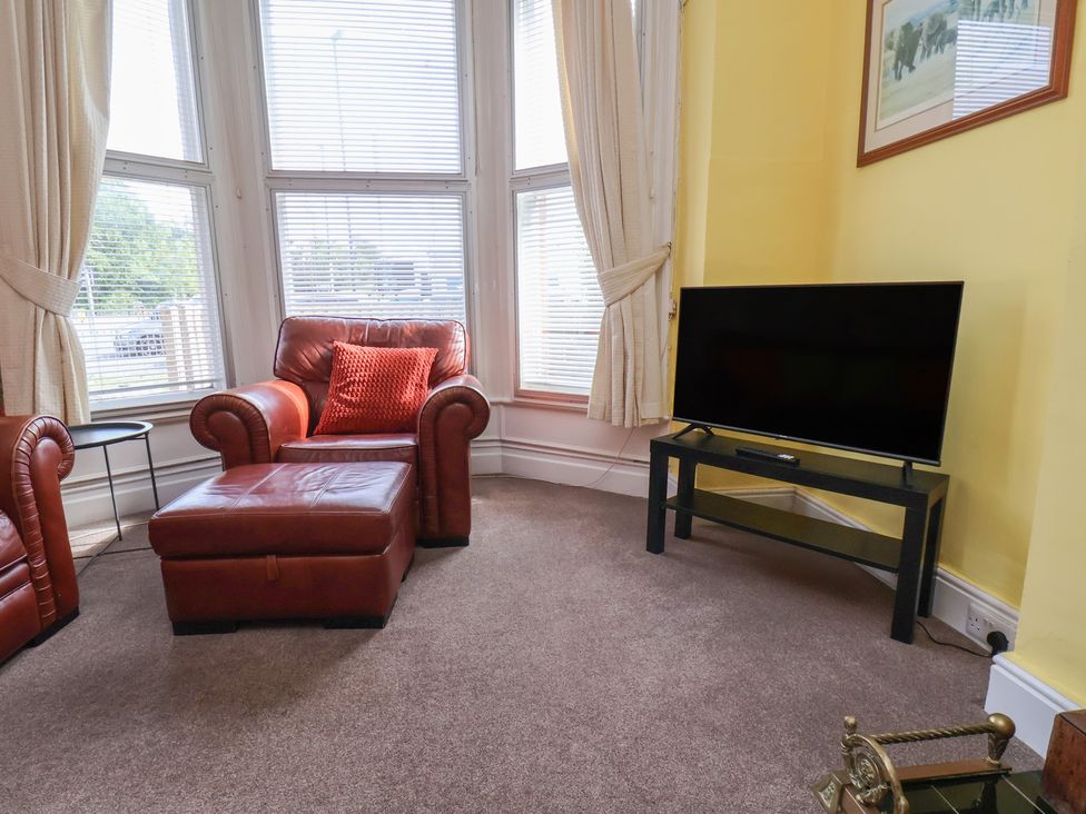 A living room with a television and an armchair at 30 Prospect Hill Whitby