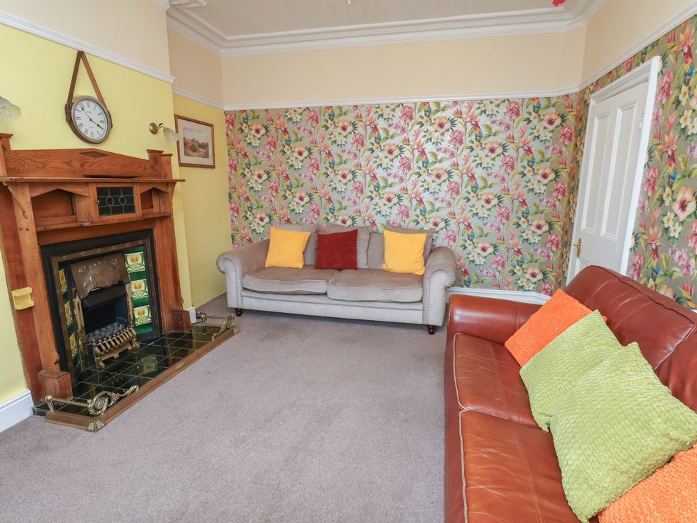 A living room with a fireplace and seating at 30 Prospect Hill Whitby