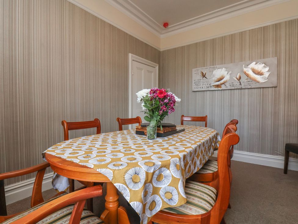 A dining room with a table and chairs at 30 Prospect Hill in Whitby