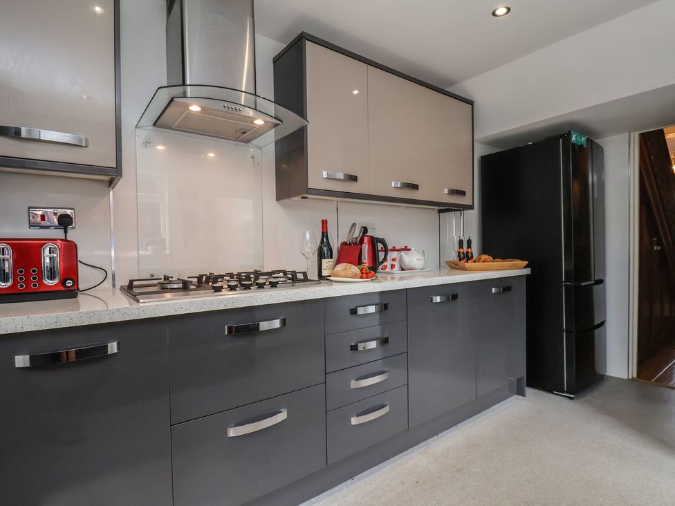 A kitchen with cabinets, stove, refrigerator, and kitchenware at 30 Prospect Hill Whitby