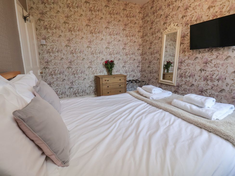A bedroom with a bed and dresser at 30 Prospect Hill, Whitby
