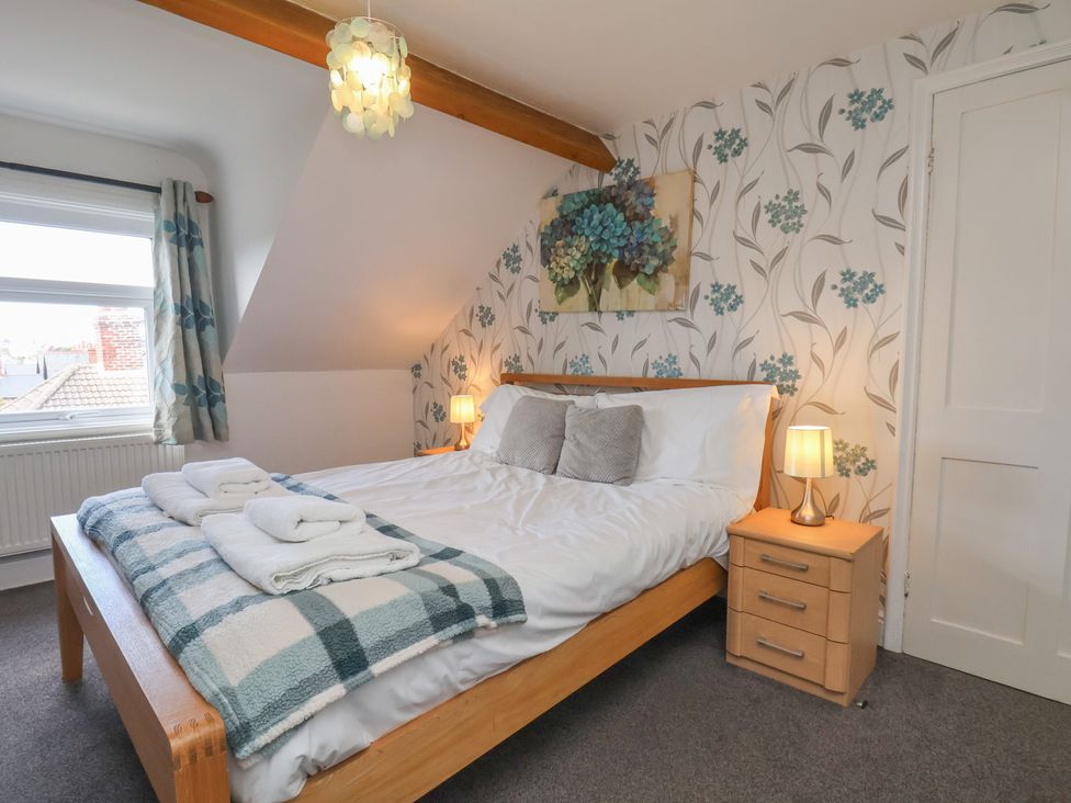 A bedroom with a bed and bedside table at 30 Prospect Hill in Whitby