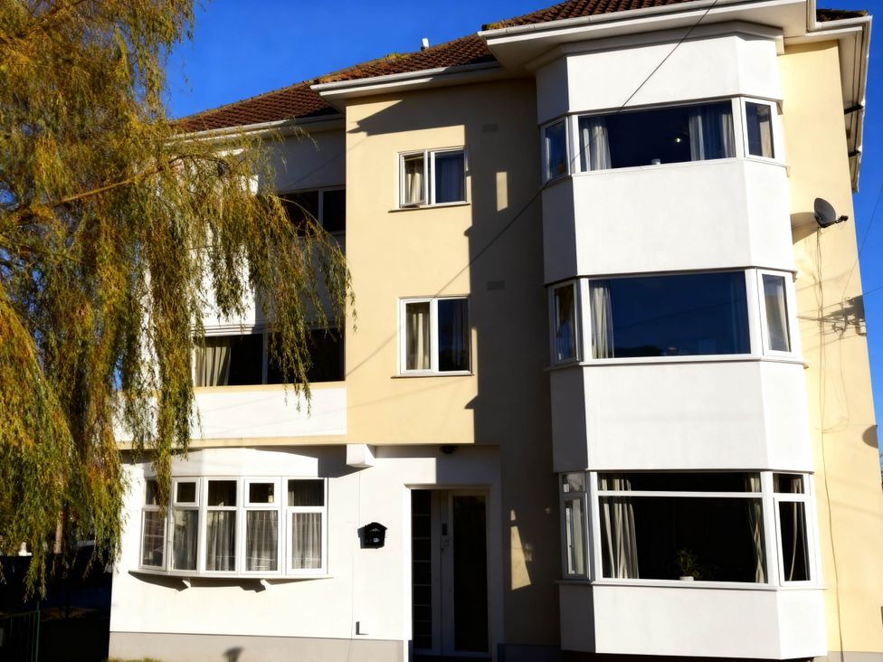 An exterior view of a building with multiple windows and a door at Balcony Apartment near Skegness Beach & Town Skegness