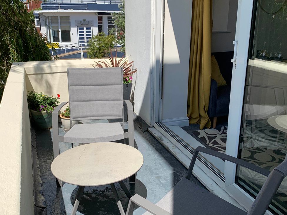 A balcony with chairs and a table at Balcony Apartment near Skegness Beach & Town in Skegness