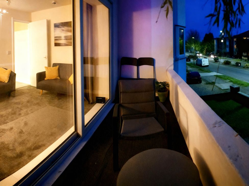 A balcony with a chair and table at Balcony Apartment near Skegness Beach & Town in Skegness