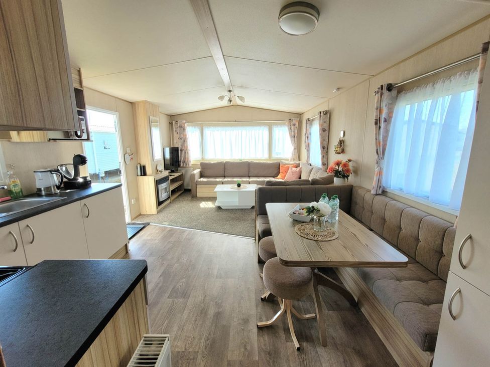 A living room with a sofa and coffee table at St Osyth- Sleeps8-freeparking-wifi-holidaypark, Clacton-On-Sea