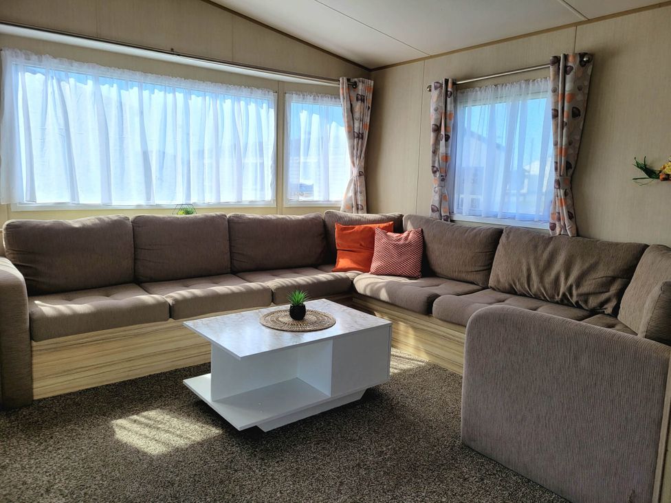 A living room with a sofa and coffee table at St Osyth- Sleeps8-freeparking-wifi-holidaypark in Clacton-On-Sea