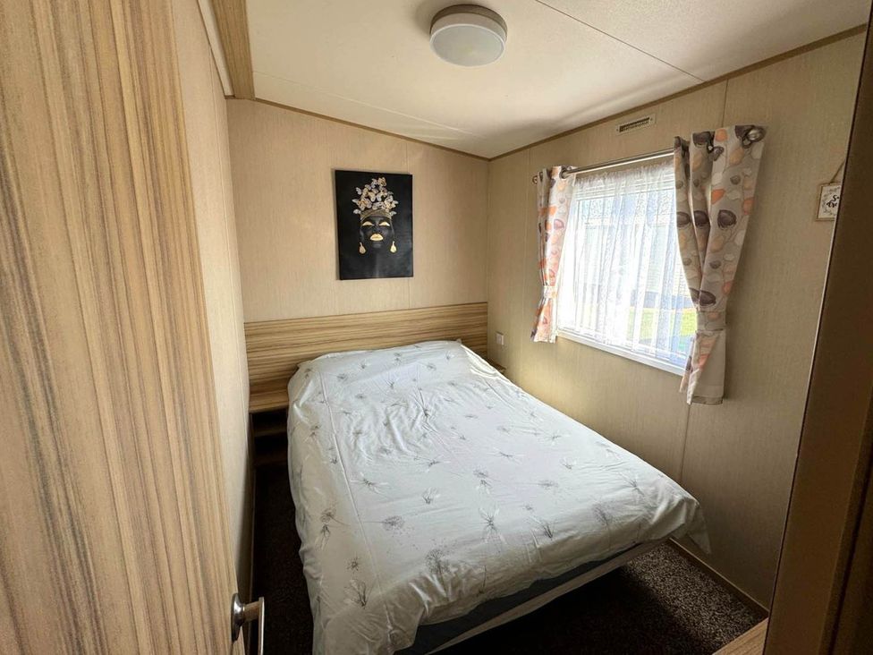 A bedroom with a bed and window at St Osyth- Sleeps8-freeparking-wifi-holidaypark Clacton-On-Sea