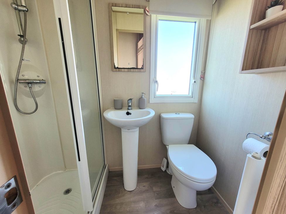 A bathroom with a shower, sink, and toilet at St Osyth- Sleeps8-freeparking-wifi-holidaypark Clacton-On-Sea