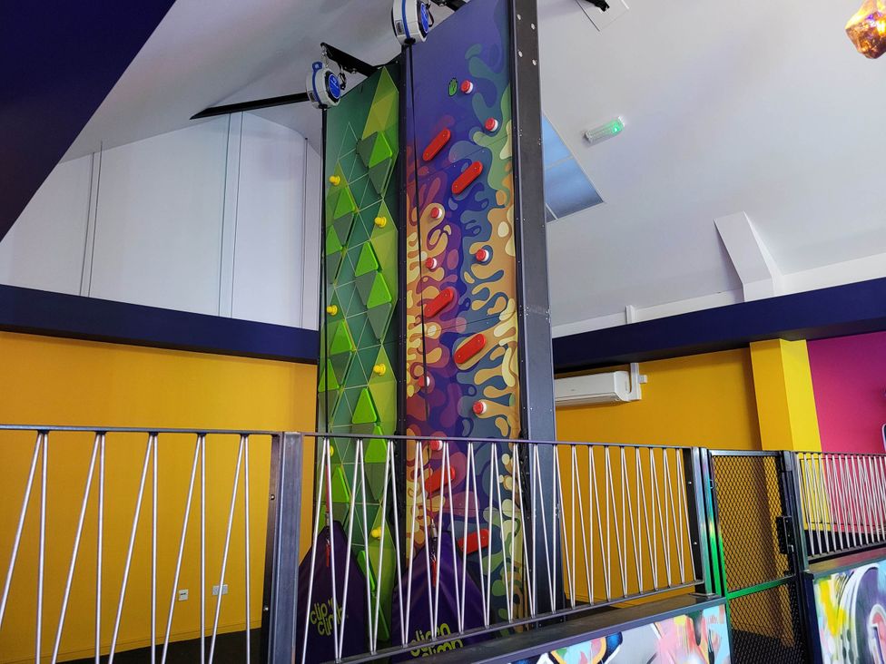 An indoor play area with a climbing wall and colorful panels at St Osyth- Sleeps8-freeparking-wifi-holidaypark Clacton-On-Sea