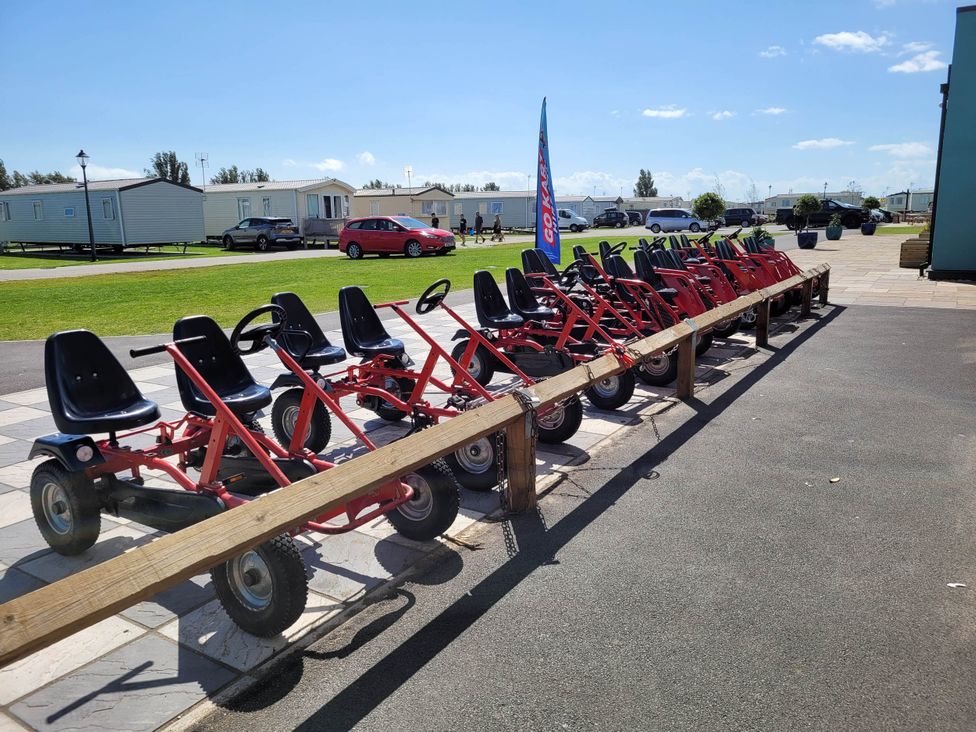 Go-karts lined up in an outdoor area at St Osyth- Sleeps8-freeparking-wifi-holidaypark Clacton-On-Sea