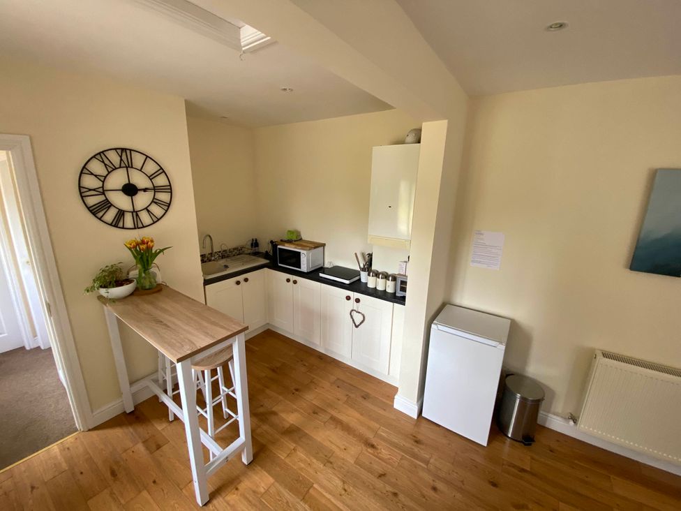 A kitchen with a sink and a microwave at Cosy stable conversion between Sheffield & Leeds Pontefract