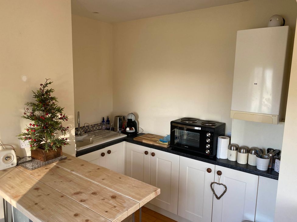 A kitchen with a sink and microwave at Cosy stable conversion between Sheffield & Leeds Pontefract