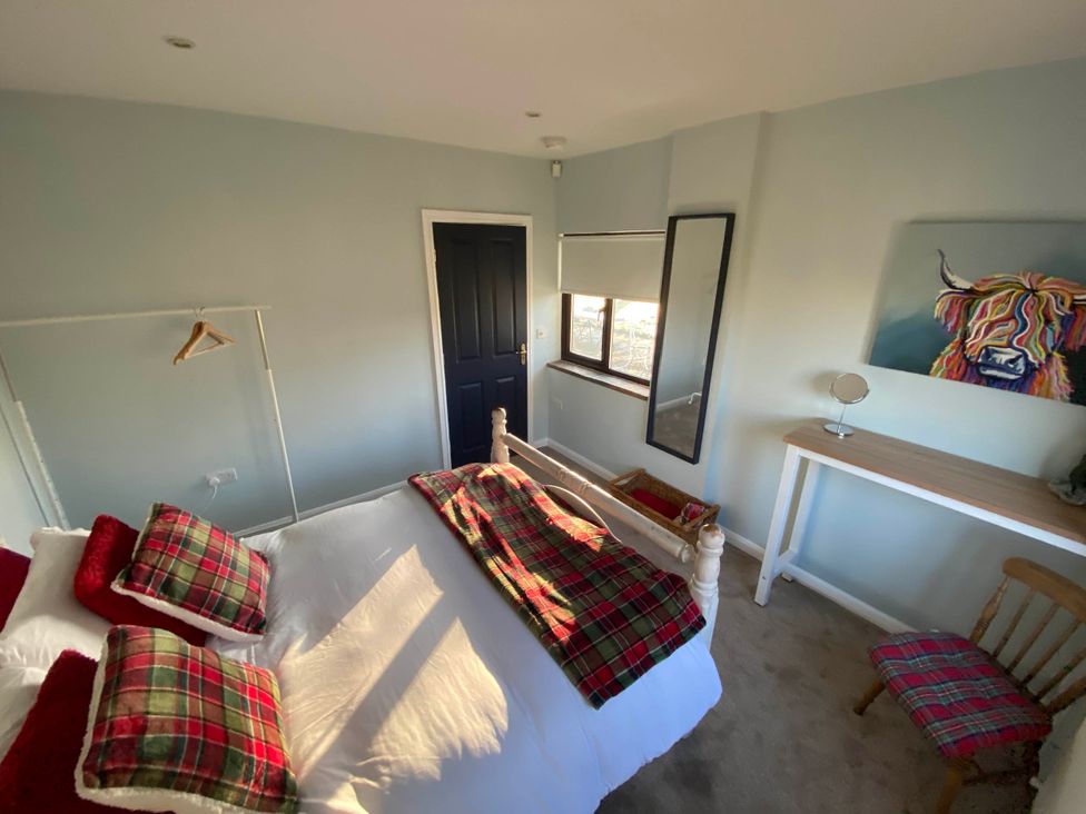 A bedroom with a bed and table at Cosy stable conversion between Sheffield & Leeds Pontefract