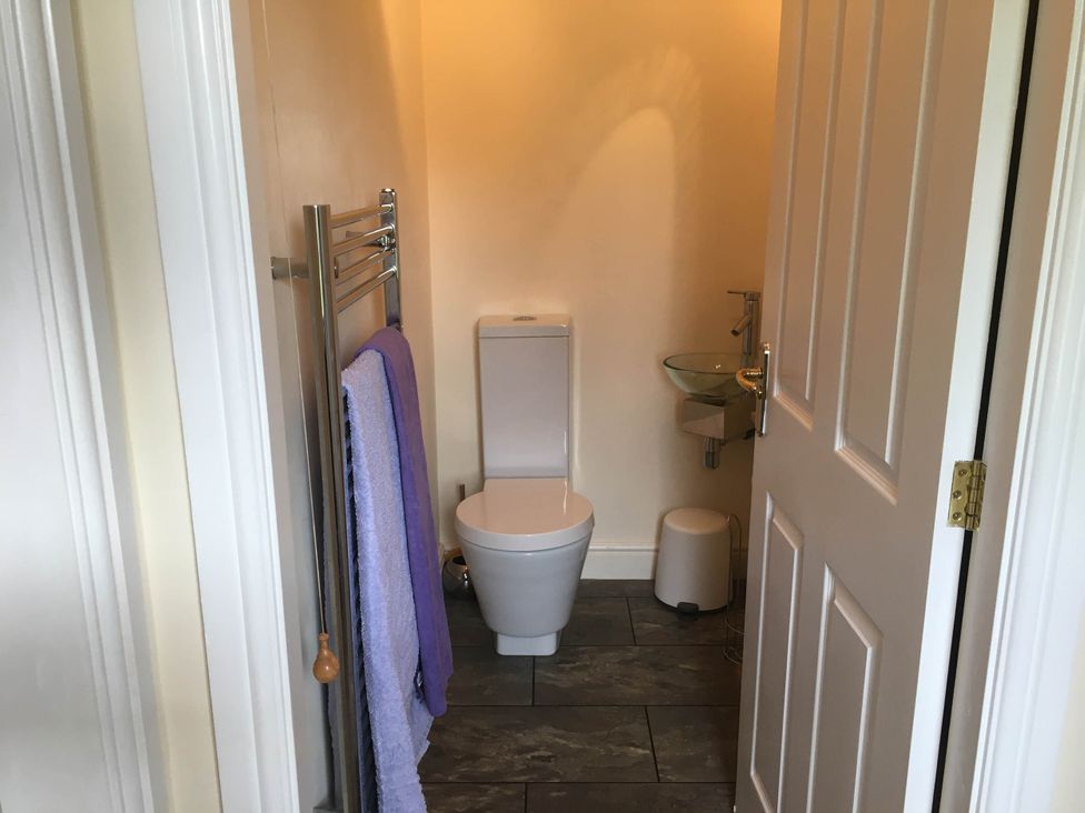 A bathroom with a toilet and hand wash basin at Cosy stable conversion between Sheffield & Leeds Pontefract