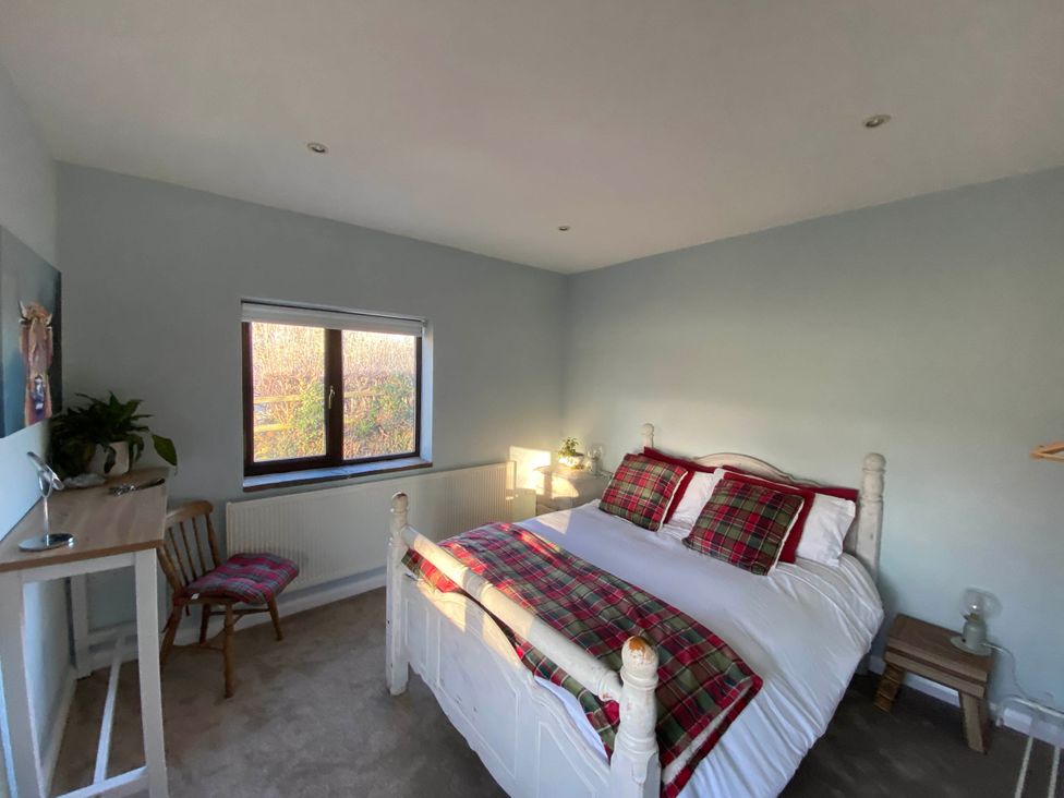 A bedroom with a bed and chair at Cosy stable conversion between Sheffield & Leeds, Pontefract