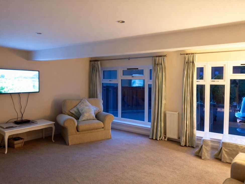 A living room with a television and armchair at 1 Bed House - Central, Free Parking, Wifi, Stirling