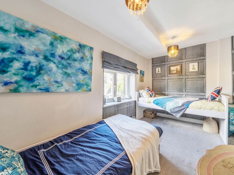 A bedroom with two beds and a window at Hebden Bridge - House - Sleeps 8 - Pet Friendly, Hebden Bridge