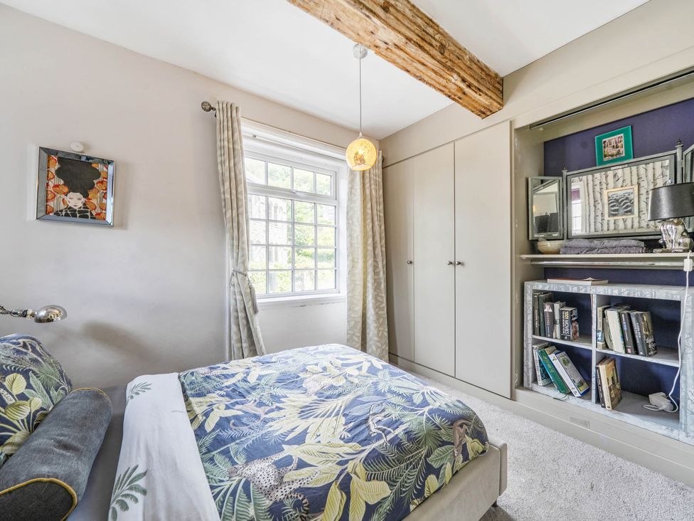 A bedroom with a bed and wardrobe at Hebden Bridge - House - Sleeps 8 - Pet Friendly, Hebden Bridge