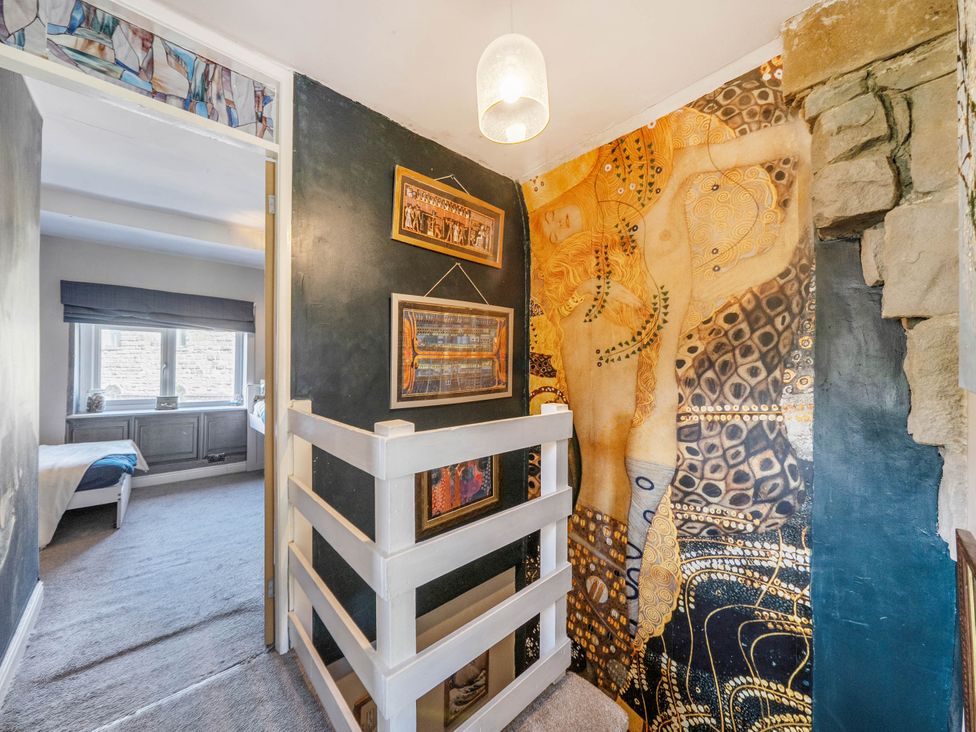 A hallway with wall art and staircase at Hebden Bridge - House - Sleeps 8 - Pet Friendly Hebden Bridge