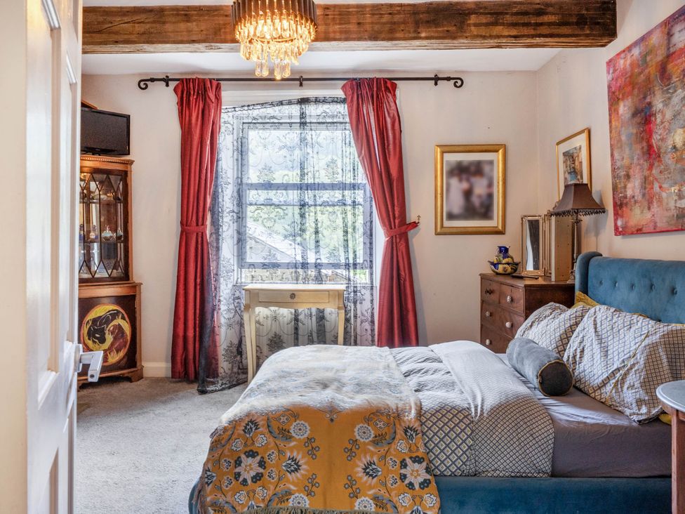 A bedroom with a bed and nightstand at Hebden Bridge - House - Sleeps 8 - Pet Friendly, Hebden Bridge