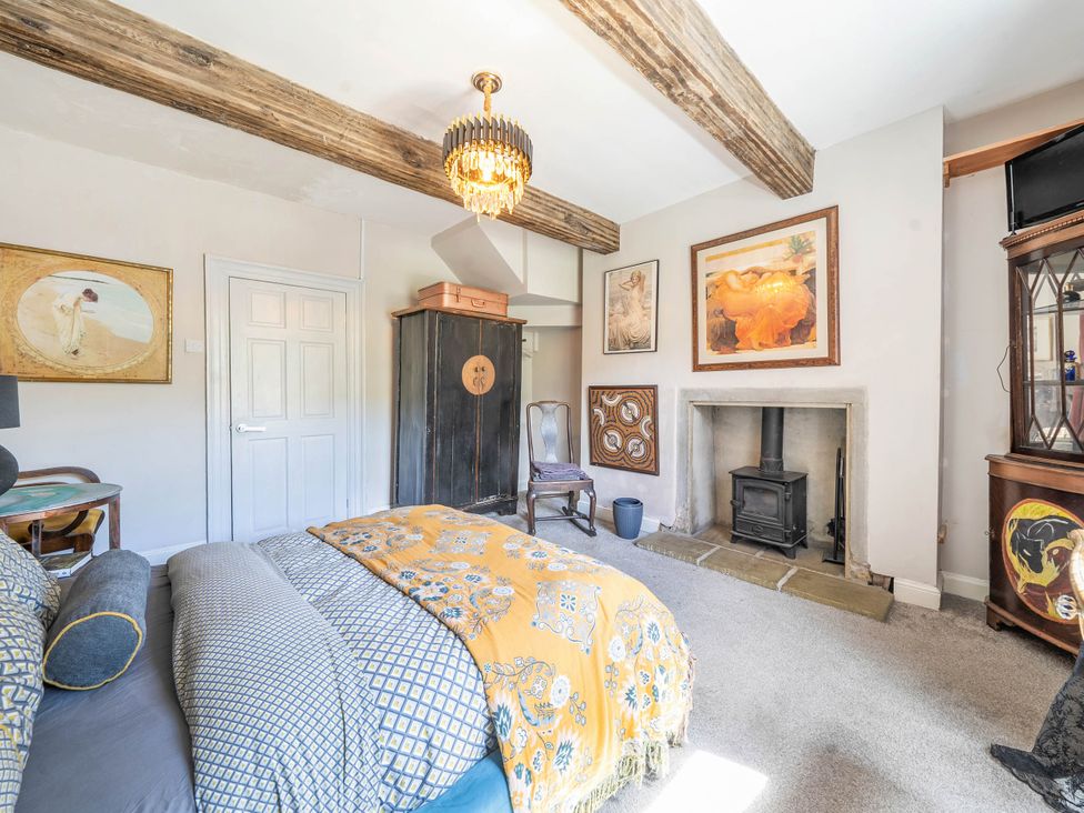 A bedroom with a bed and artwork at Hebden Bridge - House - Sleeps 8 - Pet Friendly Hebden Bridge